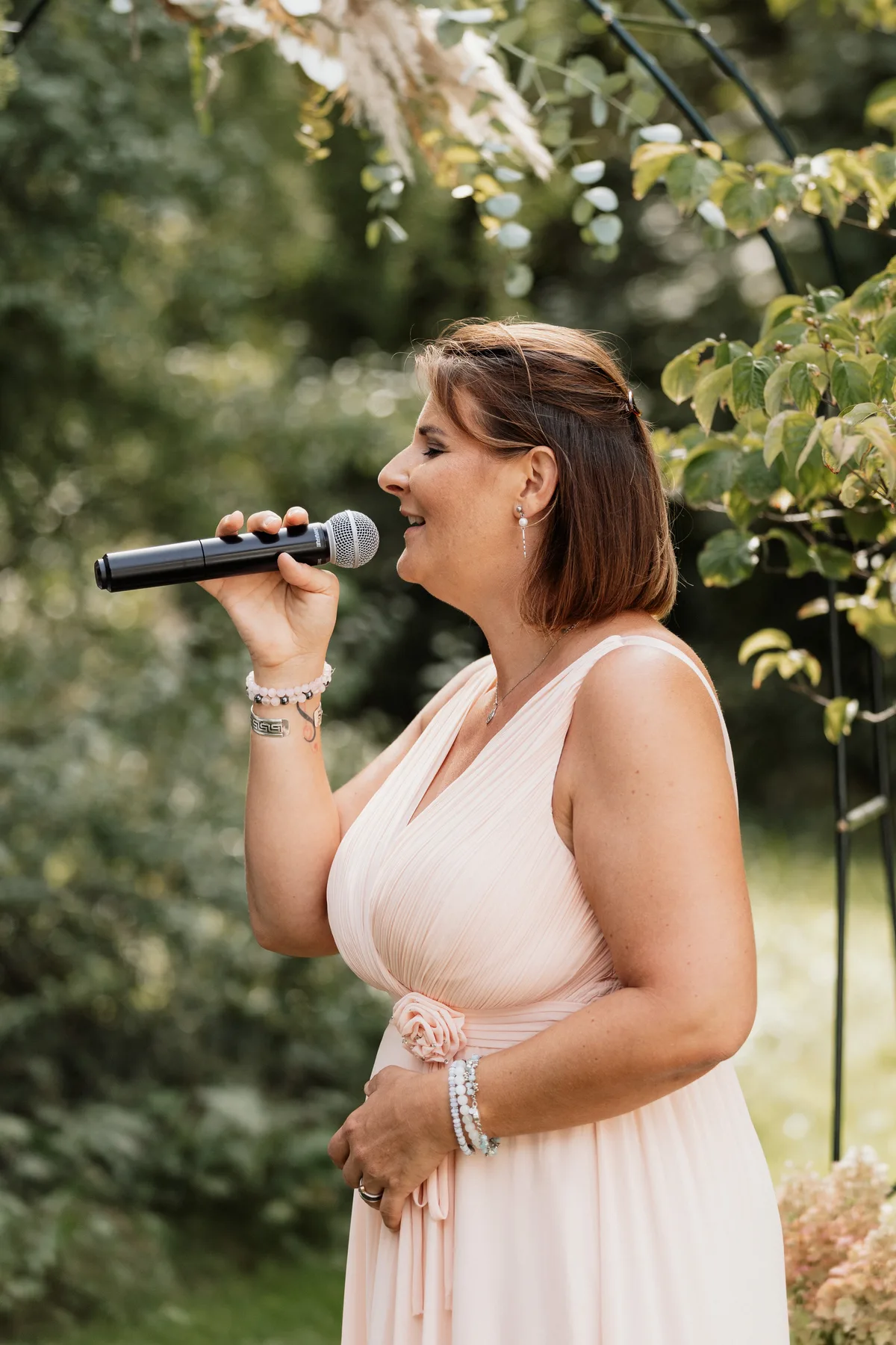 Heute singt Barbara Galli nicht mehr nur an Partys, sondern begleitet auch Hochzeiten oder Beerdigungen musikalisch. Barbara Galli mit einem Mikrofon.